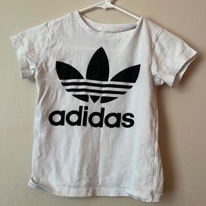 This is a white short sleeve adidas top with a black logo, size 7-8y kids